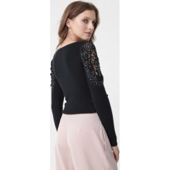 Czarny Sweter Kyla. Czarne swetry dla dziewczynek Born2be, bez wzorów, z koronki, bez kołnierzyka, bez ramiączek, długie, bez kaptura. Za 79.99 zł.