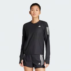 Koszulka Own The Run Long Sleeve. Czarne koszulki sportowe damskie Adidas, l, bez wzorów, z materiału, bez kołnierzyka, bez ramiączek, do biegania. Za 199.00 zł.