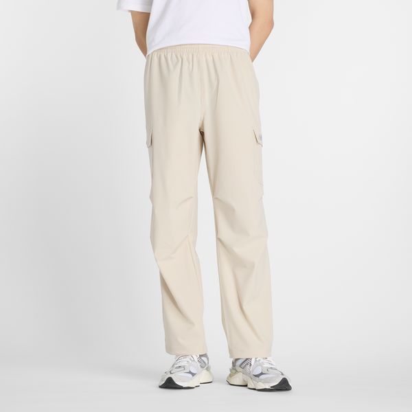 Spodnie męskie New Balance MP51538TWF – beżowe. Brązowe spodnie materiałowe męskie New Balance, m, bez wzorów, z materiału, klasyczne. Za 389.99 zł.